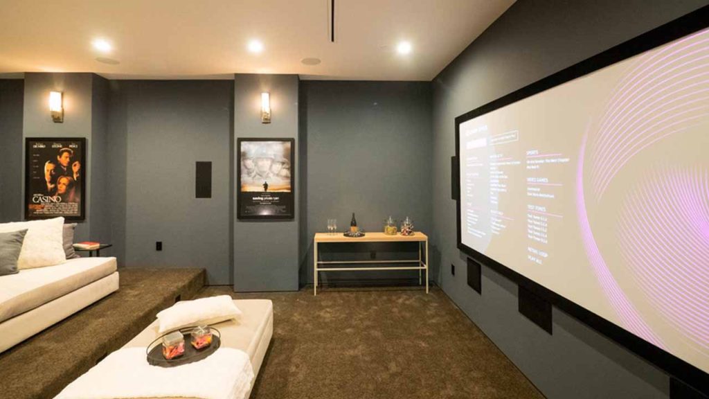 a room with a large screen on the wall